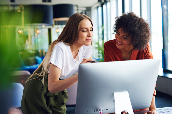 Two women working on a computer