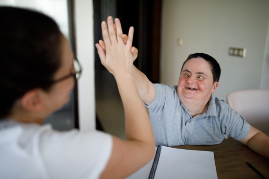 Two women high-fiving