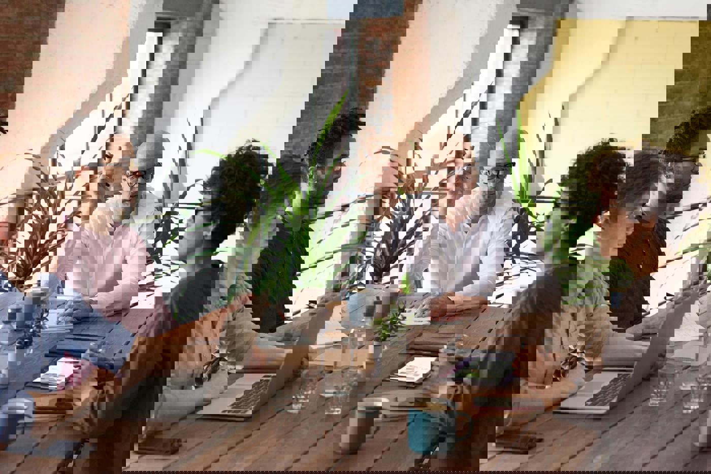 Four people sitting around a table in a business meeting