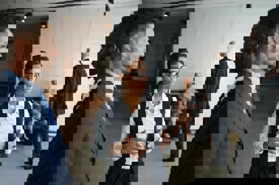 Image depicting three board members in conversation