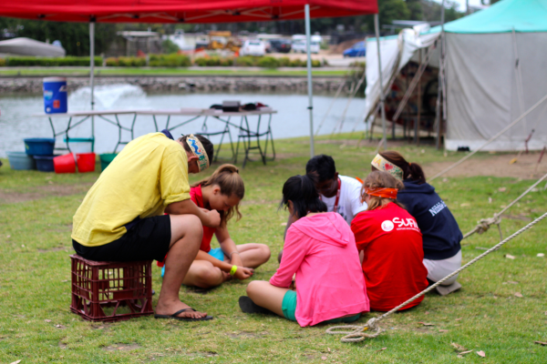 Group of young people at camp sitting in a circle