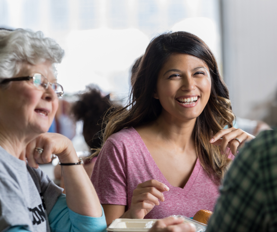 Older lady and Asian woman laughing
